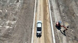A truck on a dirt road.